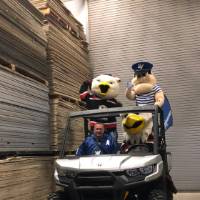 louie with the griffins mascots on the buggie